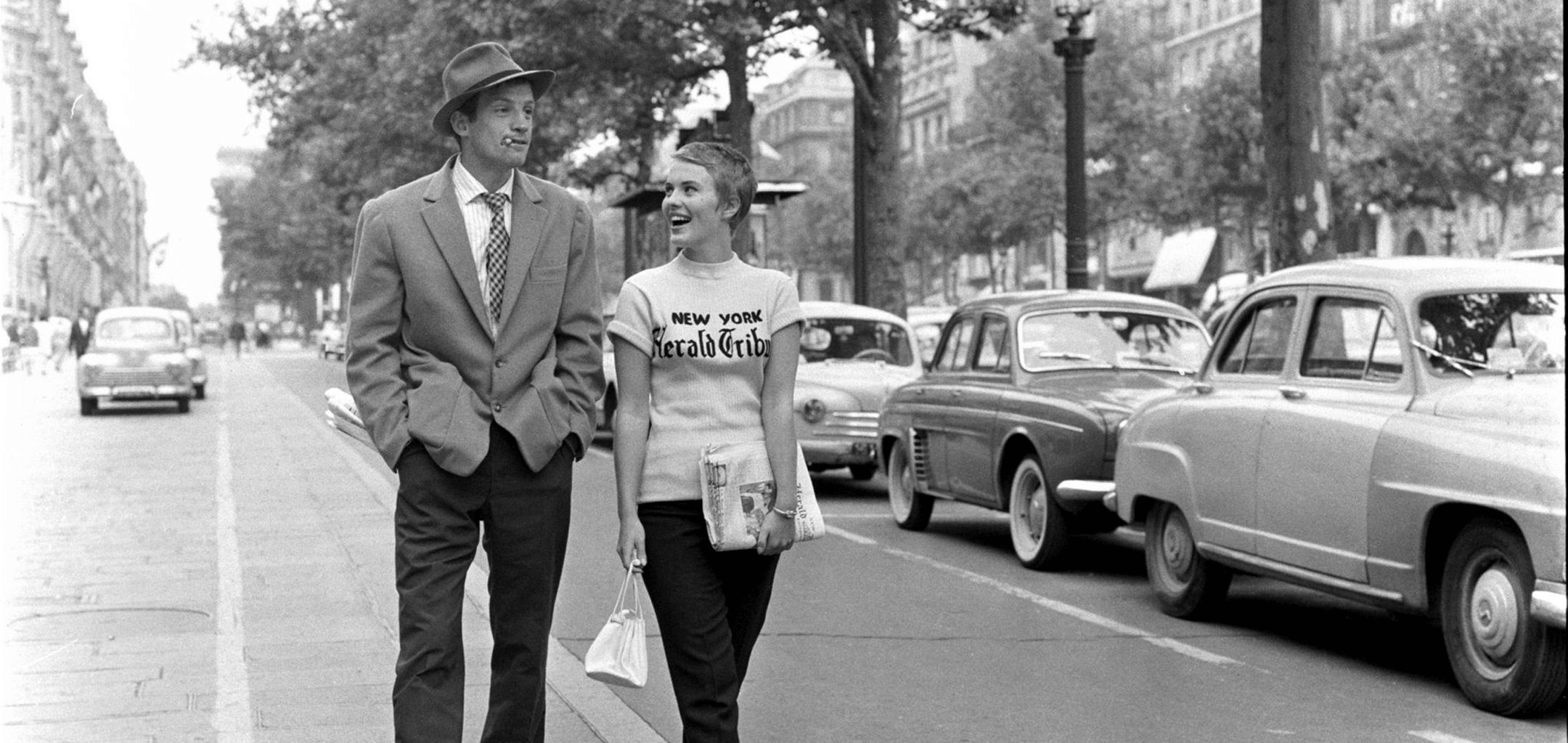 Man and woman walking down a Paris street in 1960